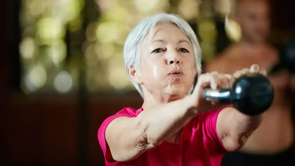 Older woman doing weight training Banbury to help her strength and longevity 